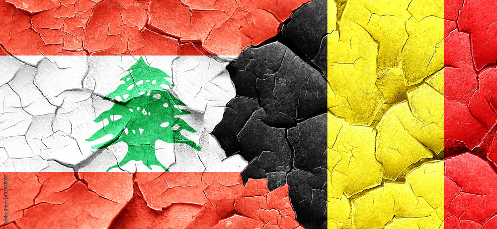 Lebanon flag with Belgium flag on a grunge cracked wall