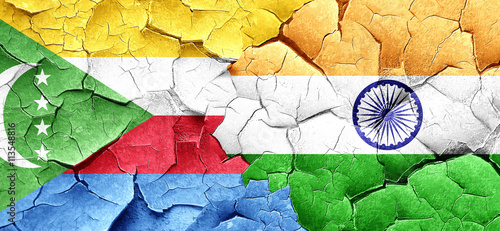 Comoros flag with India flag on a grunge cracked wall