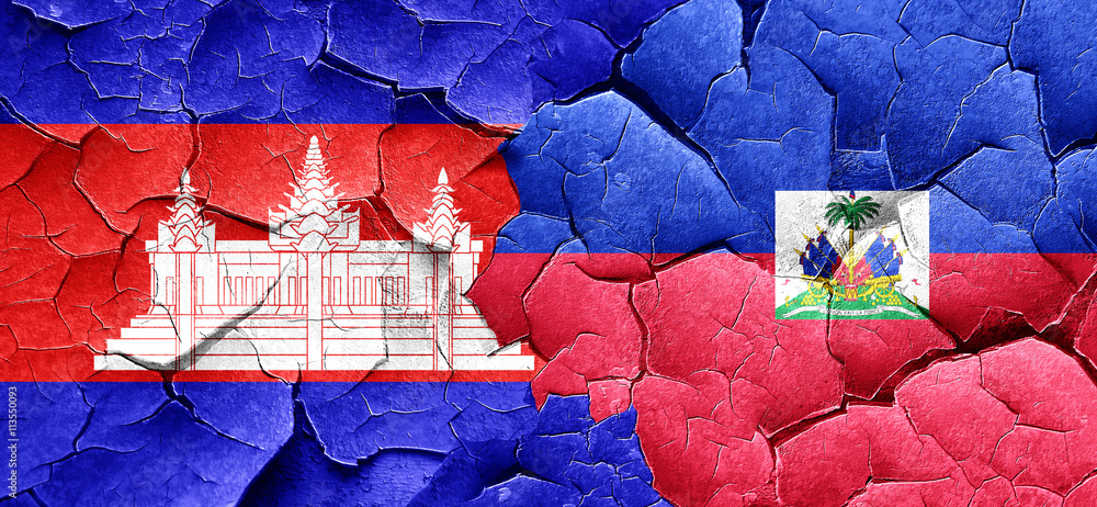 Cambodia flag with Haiti flag on a grunge cracked wall Cambodia flag with Haiti flag on a grunge cracked wall
