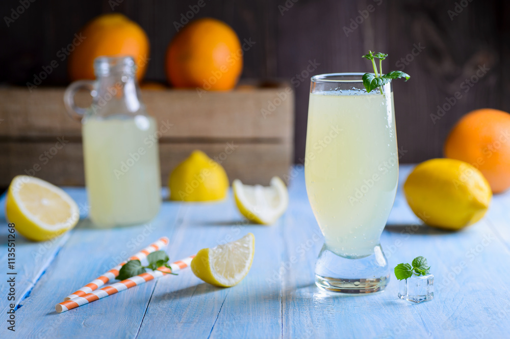 Ice cold citrus lemonade on wooden table on natural background Ice cold citrus lemonade on wooden table on natural background