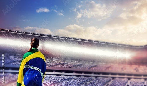 Cuadro en lienzo Rear view of sporty woman holding the Brazilian flag against composite image of