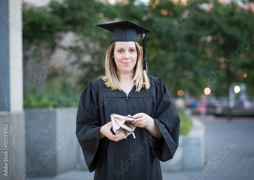 Εκτύπωση καμβά Portrait of female college student in graduation day, broke and
