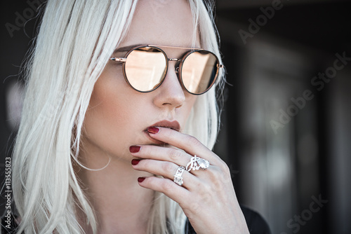 Beautiful blonde girl in sunglassses outdoor photo