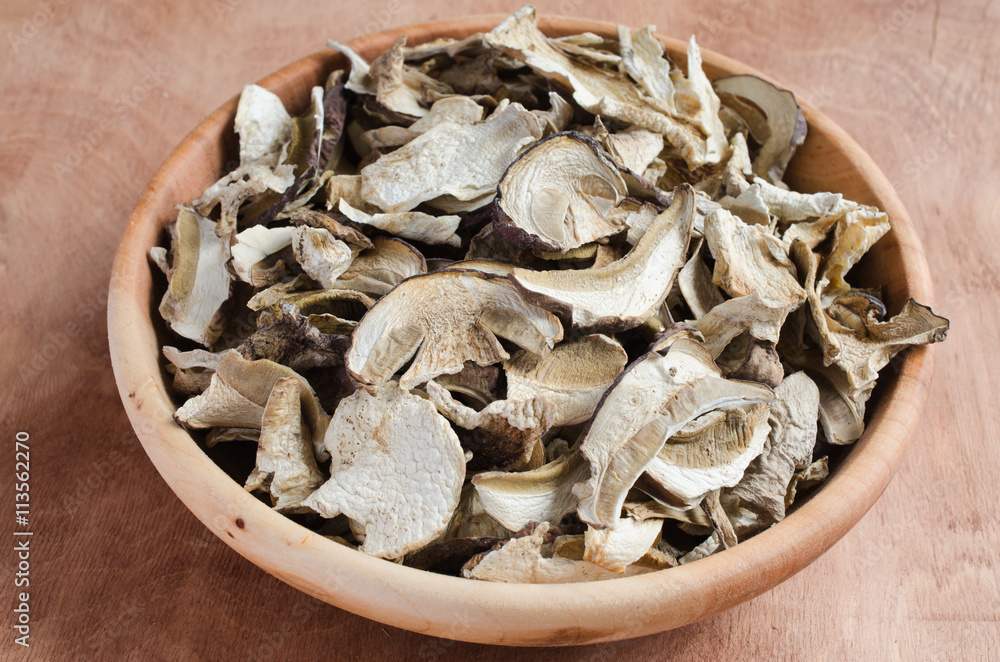 Dried porcini mushrooms on a wooden table. Rustic style. Dried porcini mushrooms on a wooden table. Rustic style.