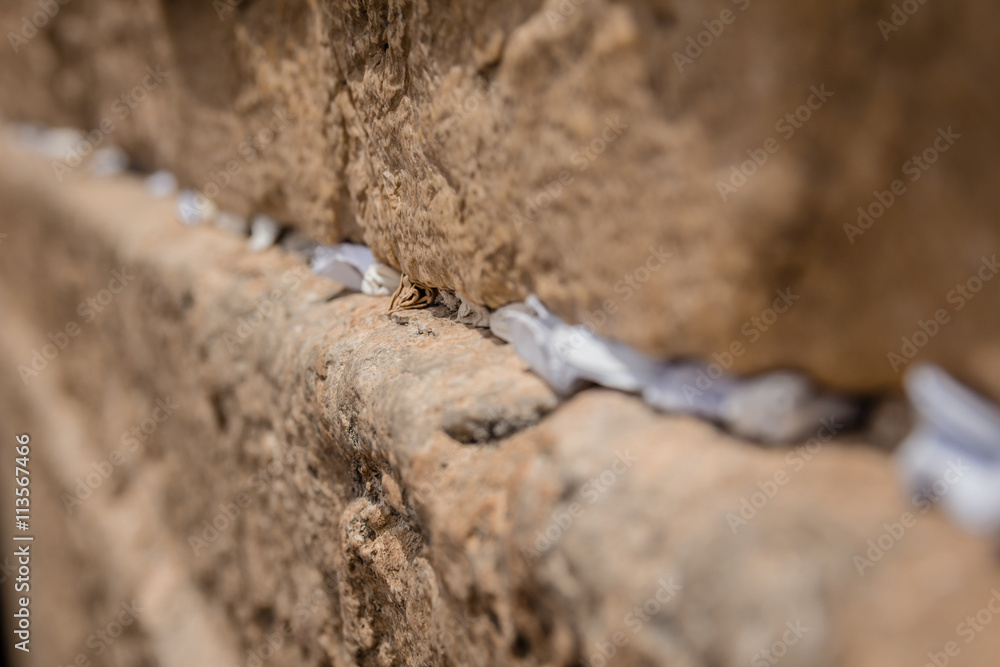 Notes to God in the cracks between the bricks of the Western Wall in the old city of Jerusalem Israel Notes to God in the cracks between the bricks of the Western Wall in the old city of Jerusalem Israel