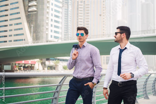 Business people walking at Dubai Marina.