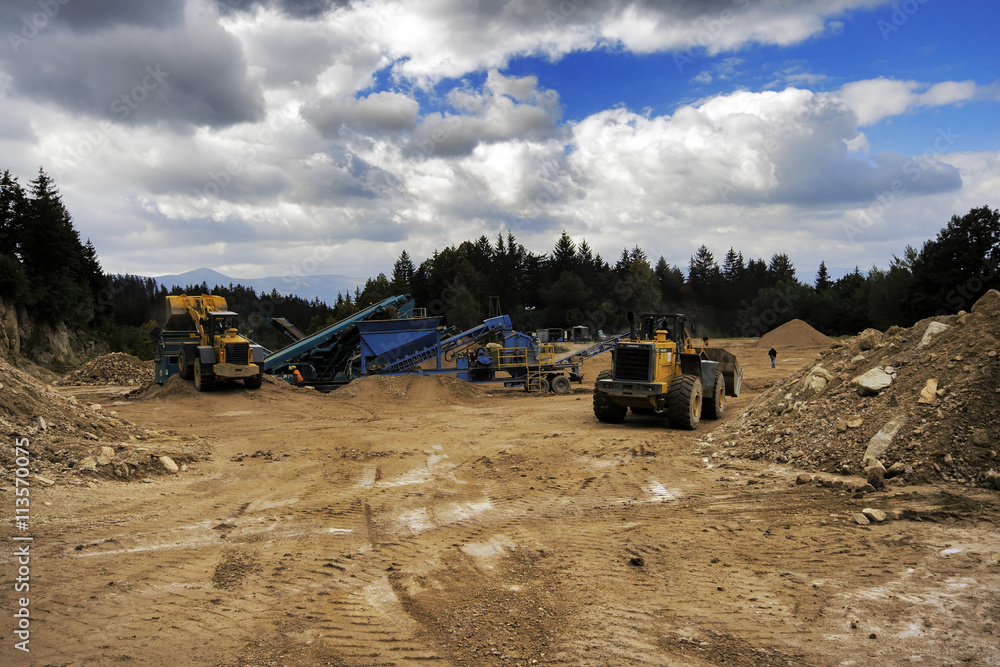 Digger And Conveyor Belt On Construction Site