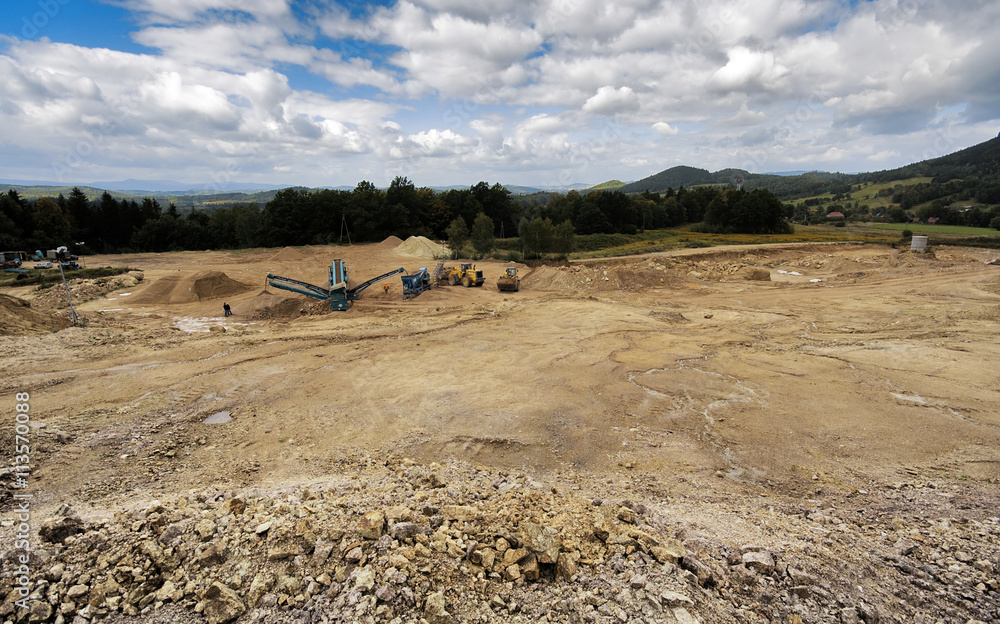 Digger And Conveyor Belt On Construction Site