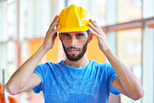 Man engineer working on blueprint in office