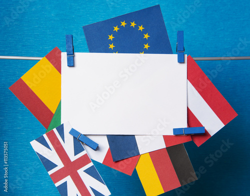 Flags of European Union (flags of different countries  eurozone) and United Kingdom, Brexit UK EU referendum concept. placard for text photo