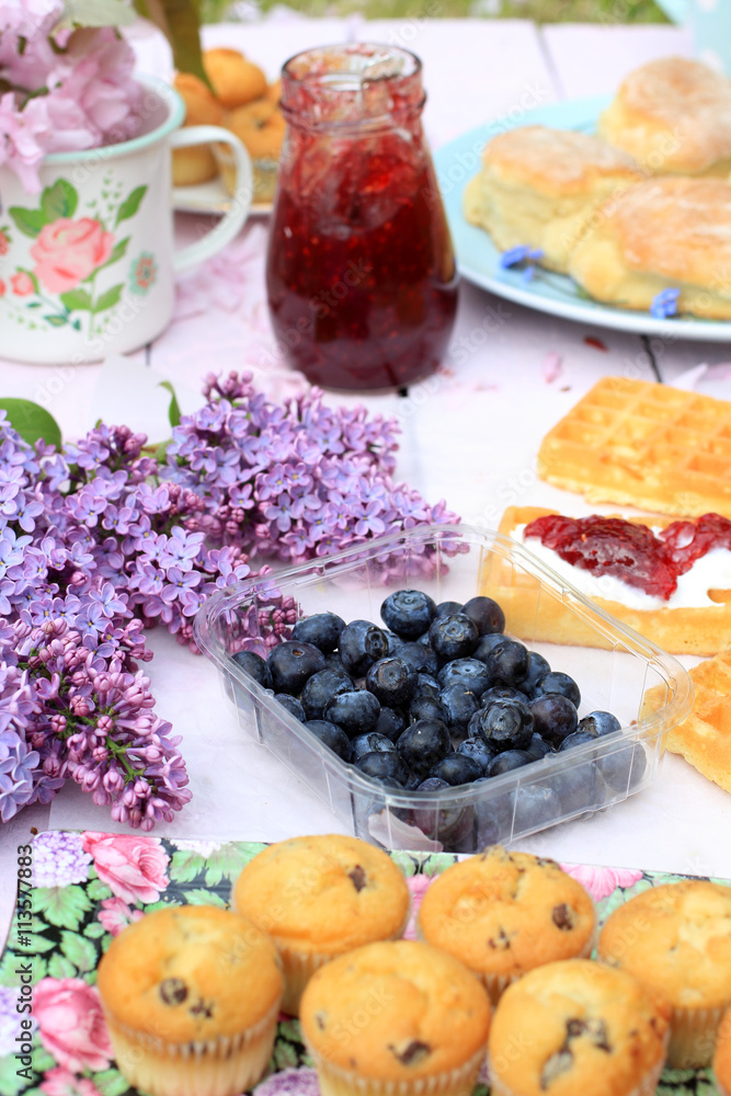 Delicious Scottish, muffins on a wooden pink table, fresh breakfast in the Spring garden