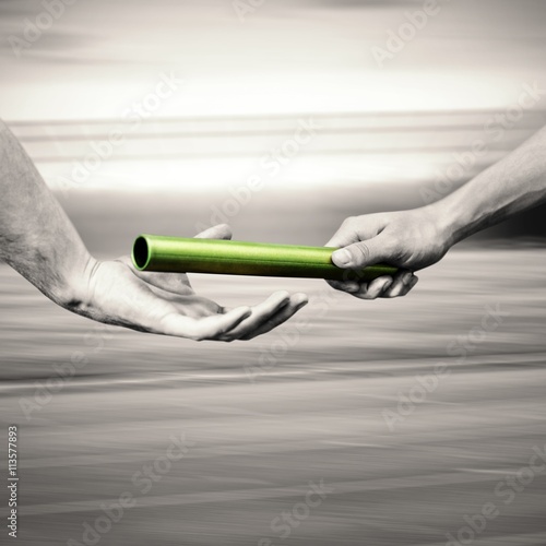  Man passing the baton to partner on track photo