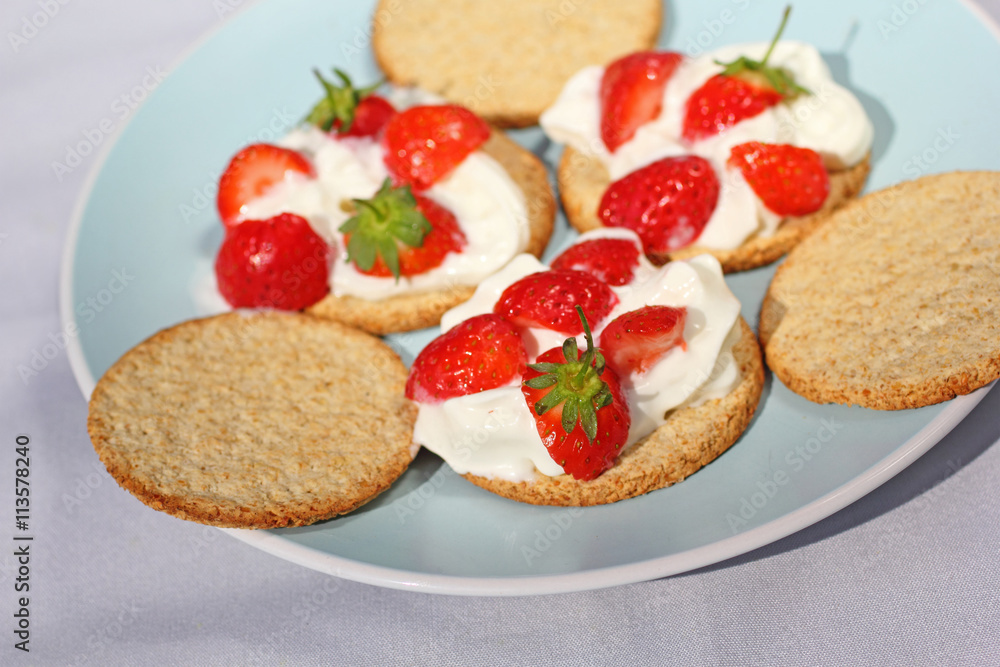 Oat buiscits with cream and fresh strawberries, close up Oat buiscits with cream and fresh strawberries, close up