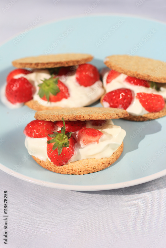 Oat buiscits with cream and fresh strawberries, close up Oat buiscits with cream and fresh strawberries, close up