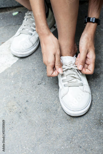 girl shoe laces  Female athlete getting ready for walking 