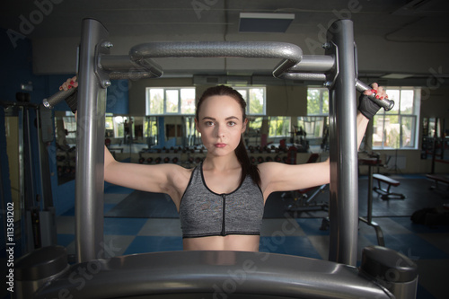 Young happy woman training in the gym