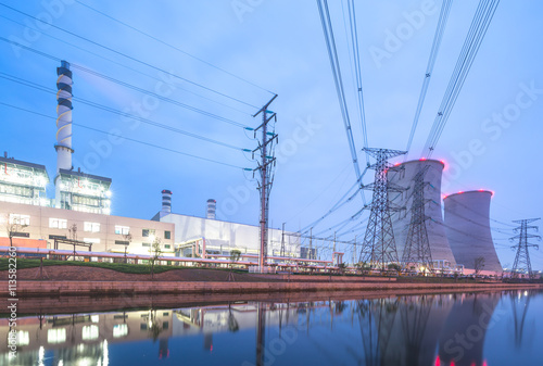 modern power station near river at twilight