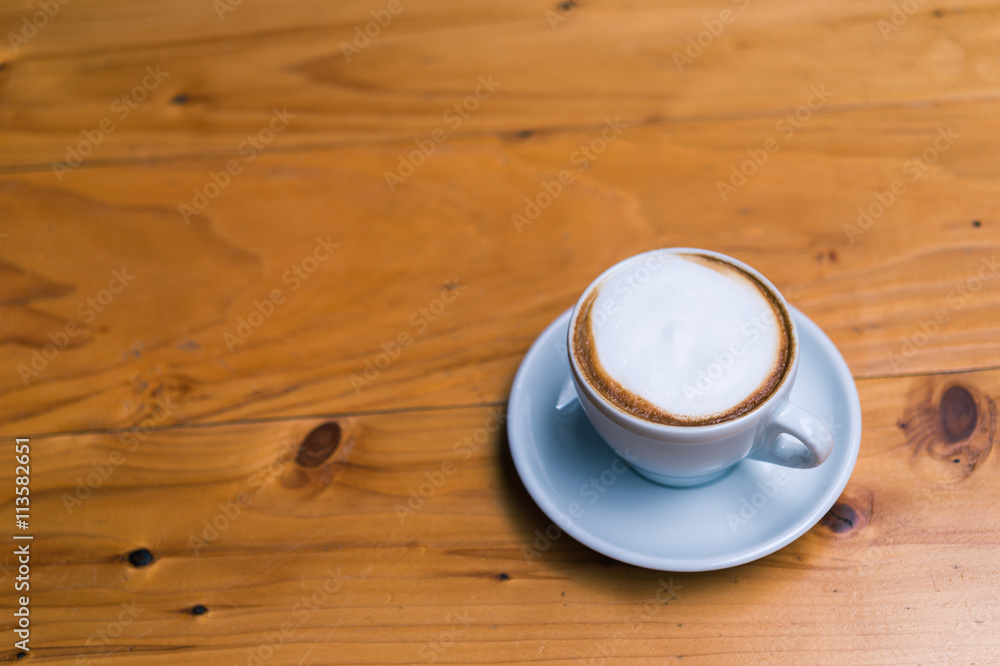 Late art coffee on wood table background