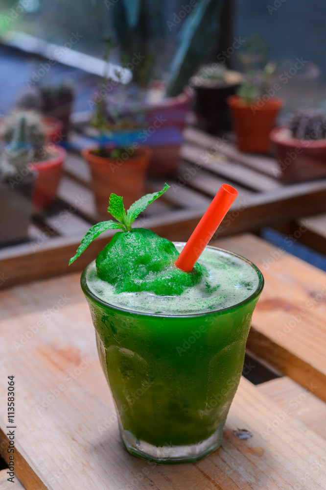 Lime mint smoothie on wooden table