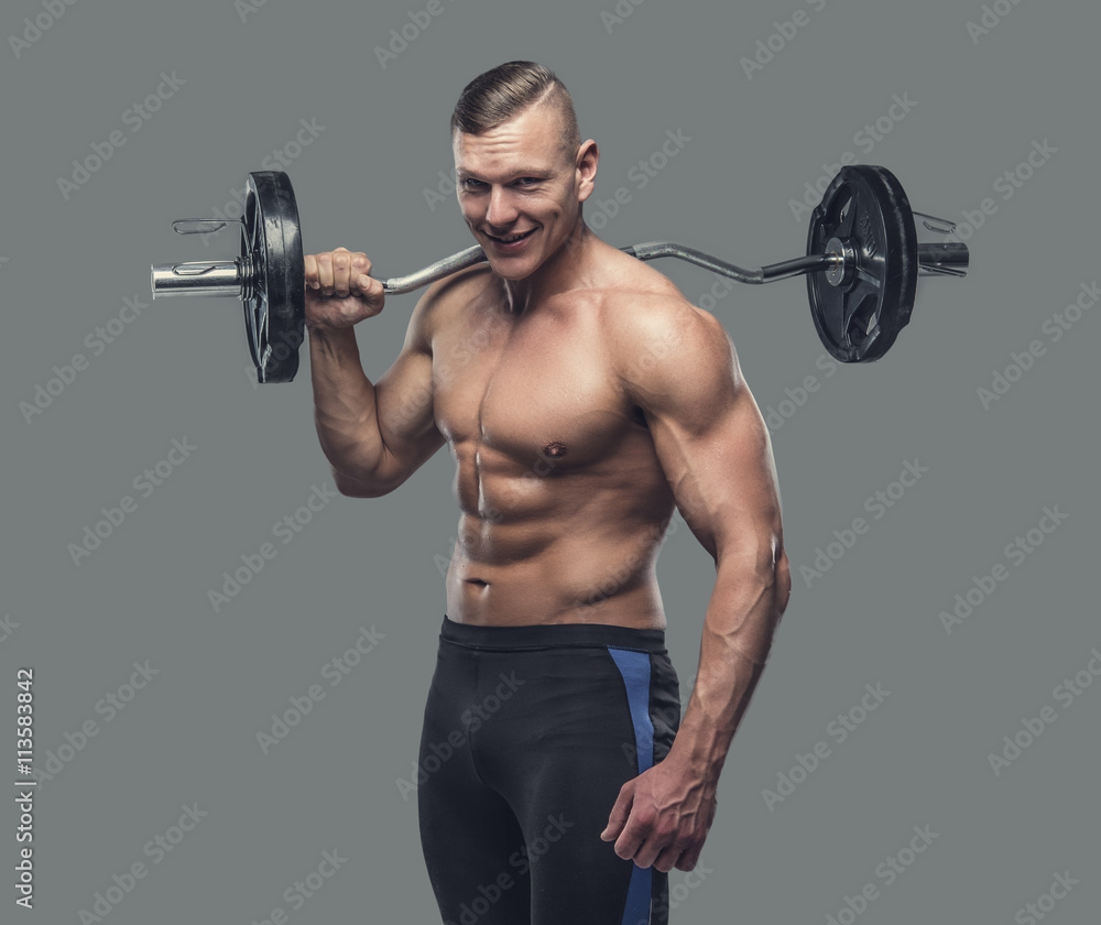 A man holding barbell on his shoulder.
