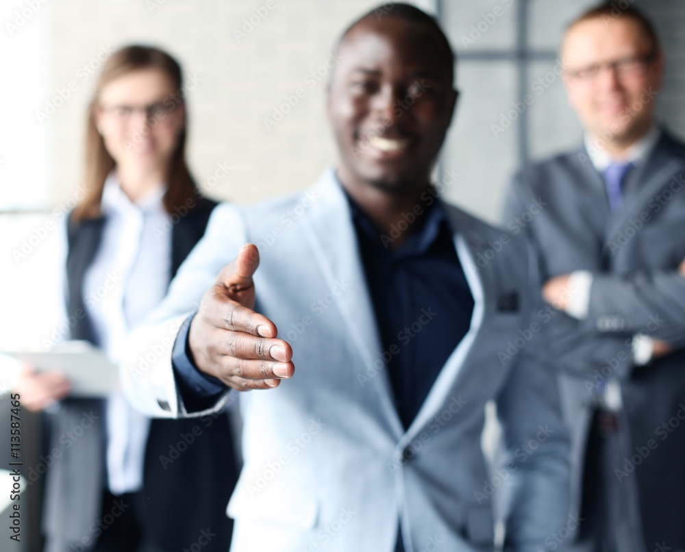 Portrait of an African American business man with an open hand ready to seal a deal Portrait of an African American business man with an open hand ready to seal a deal