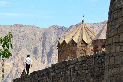 Man walking on the wall of Armenian church in iran photo