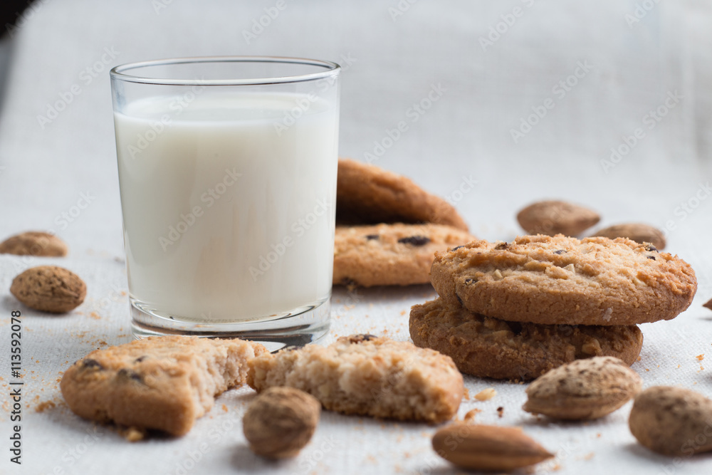 Cookies pile with chocolate chip and almond on light textile background. Delicious morning snacks for breakfast, brunch and lunch. Appetizing, healthy and fast food Cookies pile with chocolate chip and almond on light textile background. Delicious morning snacks for breakfast, brunch and lunch. Appetizing, healthy and fast food