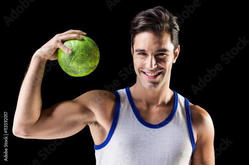 Portrait of happy male athlete holding a ball