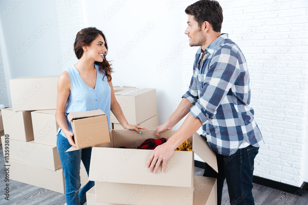 Young pretty couple unpacking in new flat Young pretty couple unpacking in new flat