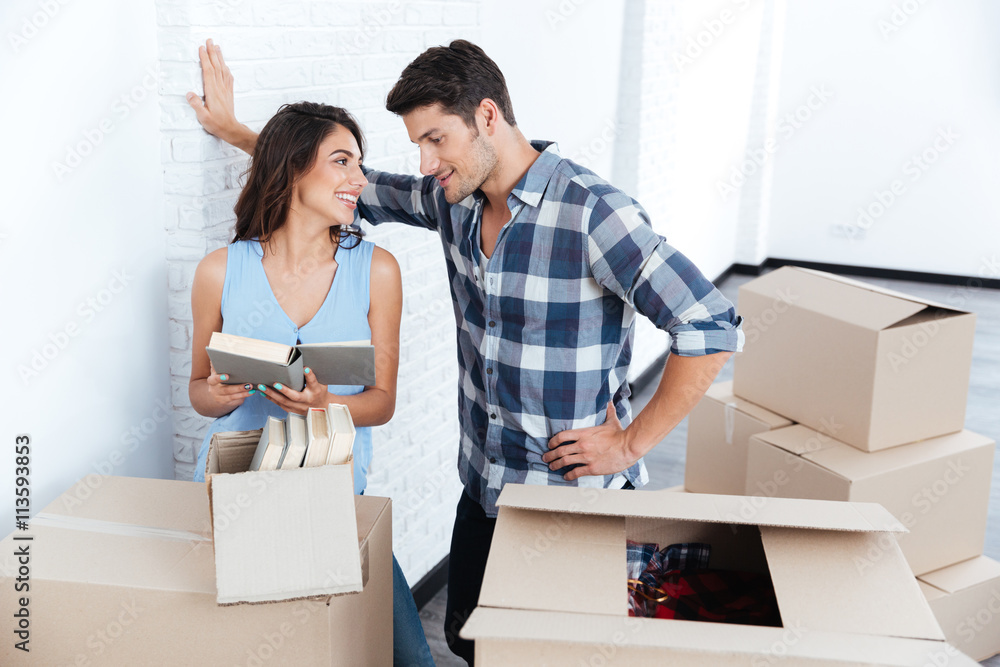 Young beautiful couple unpacking in new flat Young beautiful couple unpacking in new flat