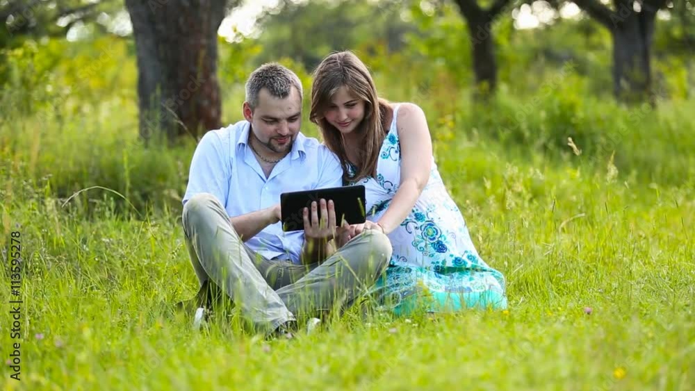 Happy pregnant couple with tablet Happy pregnant couple with tablet