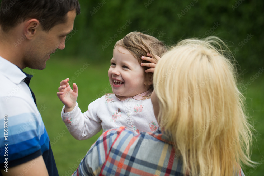 Fototapeta premium Happy parents with little girl