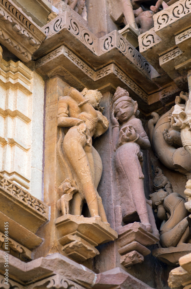 Erotic sculpture of lovers at famous ancient temple in Khajuraho, India