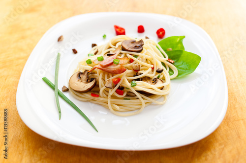 Pasta with mushrooms and vegetables on a plate