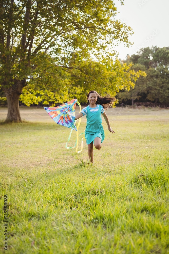 Happy girl playing with kite in park Happy girl playing with kite in park
