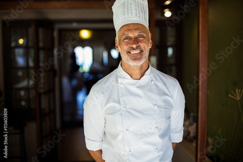 Portrait of chef standing with hands behind back photo