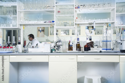 Clean modern white medical or chemical laboratory background. Laboratory concept with caucasian male chemist. Horizontal template for a poster, webpage or leaflet.