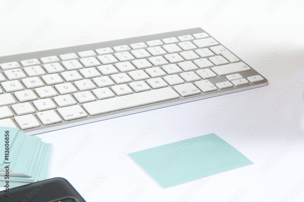 Business desk template with keyboard and blank business cards for small business or home office, viewed overhead Business desk template with keyboard and blank business cards for small business or home office, viewed overhead
