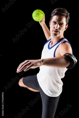 Portrait of athlete man throwing a ball 