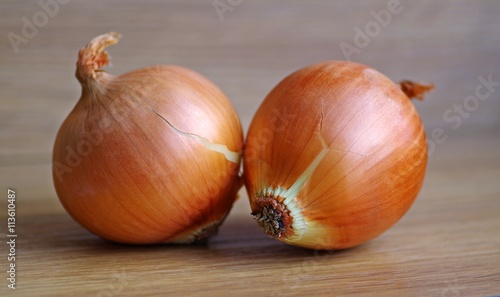 Fresh organic raw onions on a rustic wooden background. Onion vegetable.