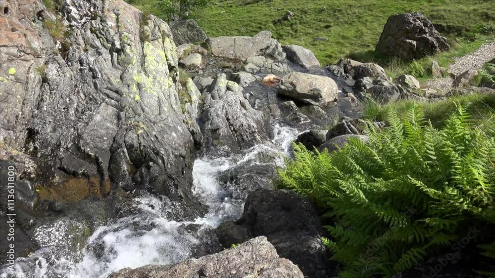 Cold water flowing down a mountain stream in the English Lake District. Cold water flowing down a mountain stream in the English Lake District.