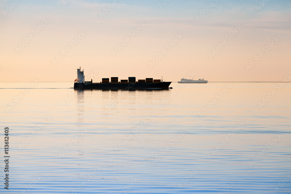 Big industrial container ship goes on still sea Big industrial container ship goes on still sea