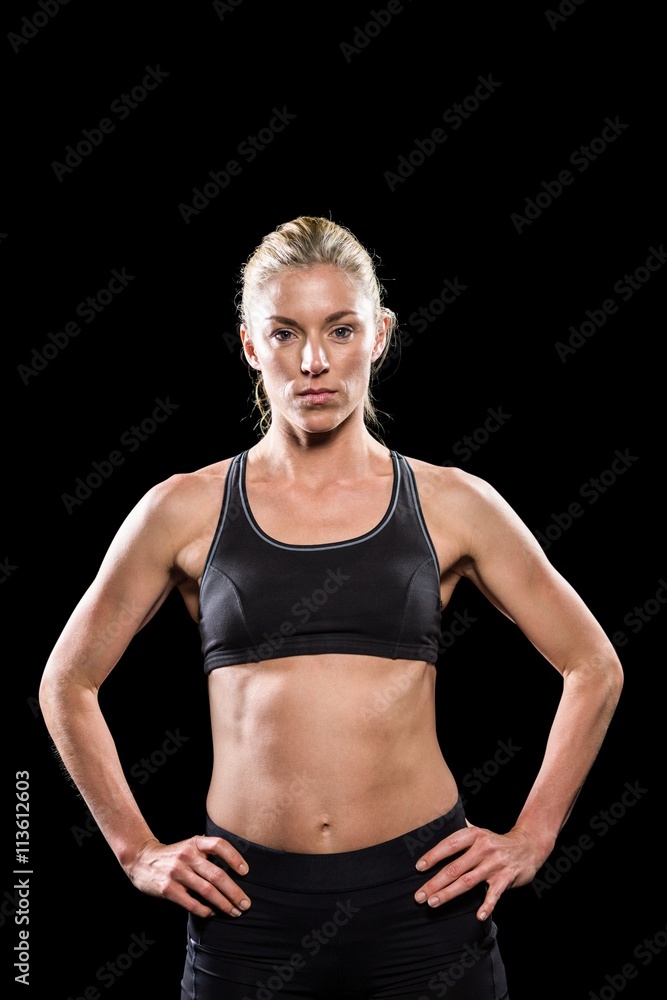 Female athlete standing with hand on hip Female athlete standing with hand on hip