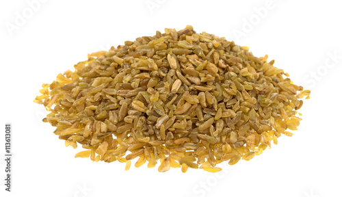 Portion of cracked freekeh on a white background side view. photo