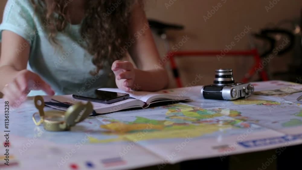 Girl preparing to travel using the map Girl preparing to travel using the map