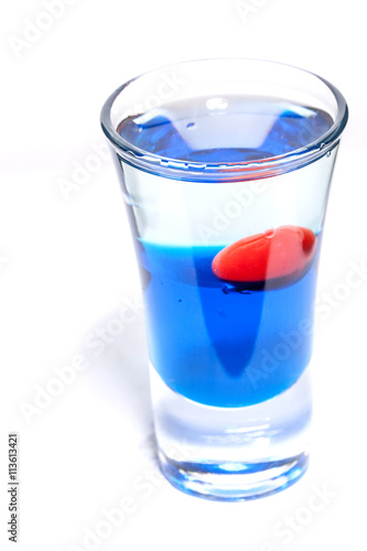 alcoholic cocktail cherry with blue syrup