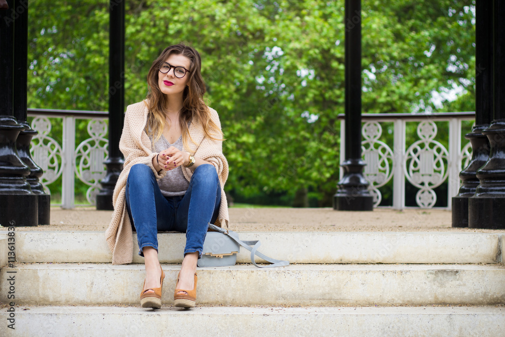 Attractive woman sitting on the stairs in the park