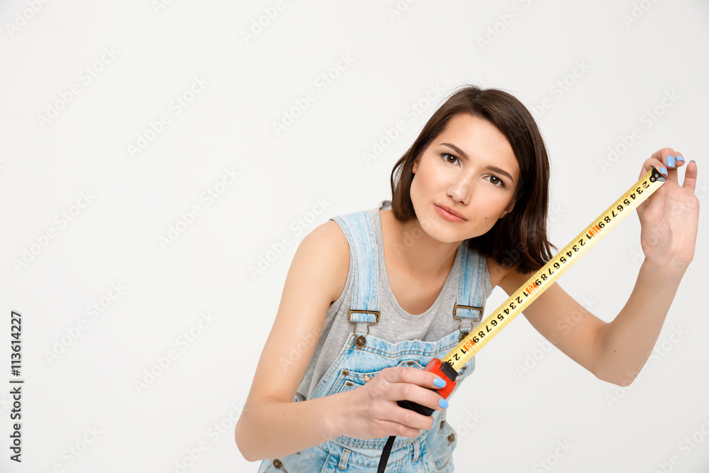 portrait of young beautiful girl, holding tape measure portrait of young beautiful girl, holding tape measure