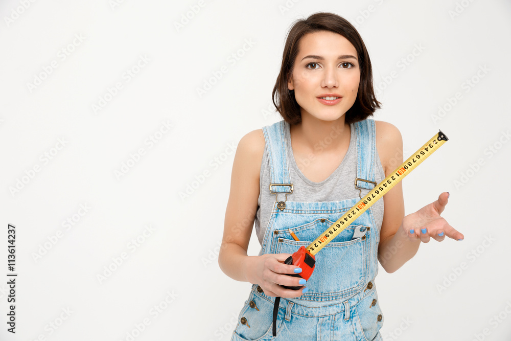 portrait of young beautiful girl, gesturing, holding tape meas portrait of young beautiful girl, gesturing, holding tape meas
