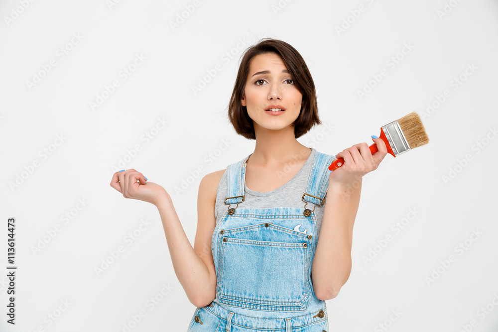 portrait of young pretty girl, looking amazed, holding paintin portrait of young pretty girl, looking amazed, holding paintin